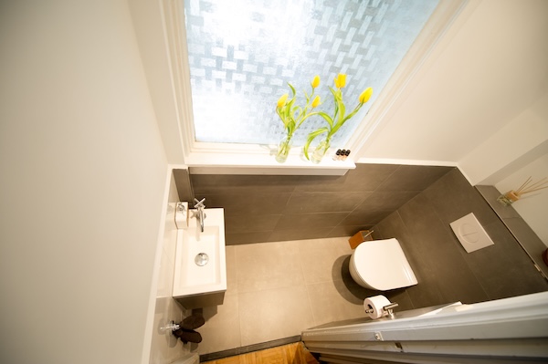 Geheel nieuw betegeld toilet, nieuwe toiletpot en fonteintje.